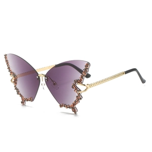 Detailed macro view of rimless butterfly sunglasses with purple gradient and crystal edge