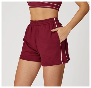 Dettaglio dei pantaloncini sportivi bordeaux a vita alta con strisce bianche e tasche