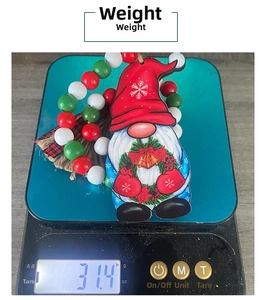 Christmas gnome wooden pendant on a digital scale showing weight of about 31.4g