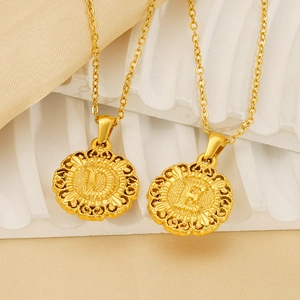 Elegant gold round initial letter pendant necklace featuring D and E on champagne satin