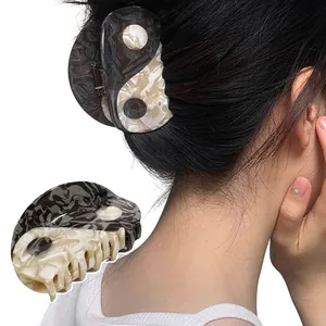 Minimalist yin yang hair claw clip with black and white marble pattern for women