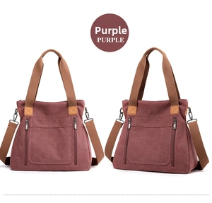 Detail of purple-brown canvas tote bag with adjustable shoulder strap and zipper pockets