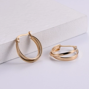 Chic multi-layered gold hoop earrings with polished metal finish on white stone base
