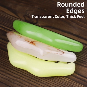 Three-piece gua sha comb set with smooth resin texture and ergonomic edges on wood