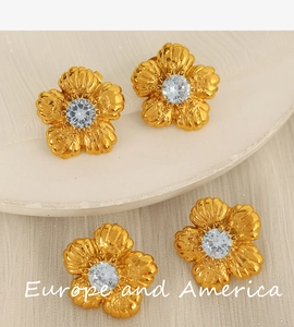 Detailed view of vintage gold flower earring with sparkling rhinestone and pearl inlay