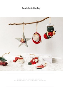 Detail of metal Christmas ornaments with Santa and reindeer hanging on branches