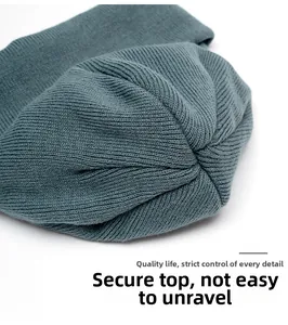 Detail of sturdy top stitching and ribbed texture on this knitted beanie hat