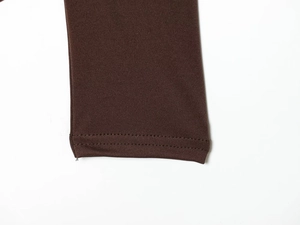 Macro shot of dark brown nylon fabric showing detailed double-needle stitching and texture