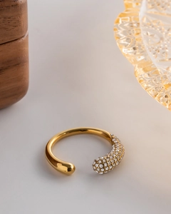 Detail of gold-plated open ring with shimmering pavé-set white zircon stones