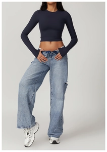 Tight-fit yoga top with thumbholes and high-waist distressed jeans for workout