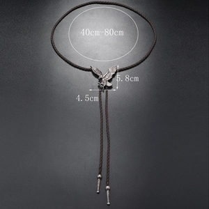 Close-up of vintage eagle bolo tie pendant with dimensions and adjustable woven cord