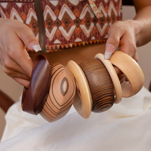 Detailed view of handmade geometric wooden bangles with natural grain textures