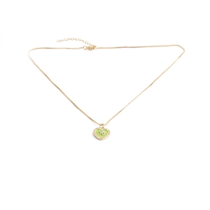 Detail of gold heart pendant with green enamel, evil eye motif and sparkling crystals