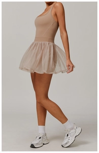 Side view of earthy-toned sleeveless athletic dress with multi-layer mesh skirt for tennis