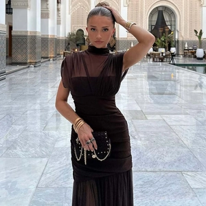 Detail of elegant brown mesh patchwork dress with pleated chest design in luxury setting