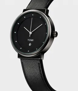 Detail shot of a minimalist quartz watch with black matte dial, date window and leather strap