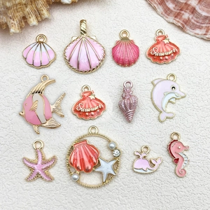 Detail of pink sea series alloy enamel charms featuring seahorse, starfish and shells