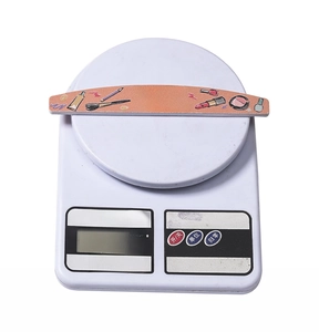 Macro shot showing double-sided nail file weighing 11.6g on a digital scale