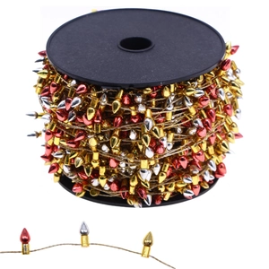 Detail of red gold and silver bullet bead chain wrapped on a black spool for Christmas tree