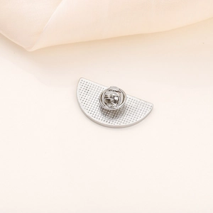 Close-up of the silver metal base and butterfly clutch of the watermelon brooch