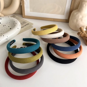 Stack of colorful handmade sponge headbands in various candy colors for a retro style