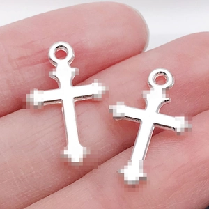 Detailed macro view of two silver cross charms for DIY jewelry and necklaces