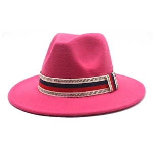 Close-up of pink wool fedora hat featuring a patterned ribbon with Greek key design