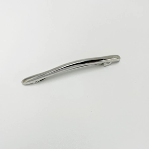 Detailed view of silver minimalist curved hair clip with polished metallic finish
