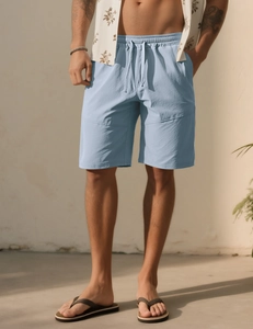 Detail of light blue men's shorts showing drawstring elastic waist and breathable fabric texture