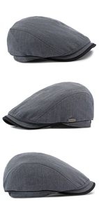 Dettaglio cappello piatto grigio a spina di pesce con logo in metallo e trama pregiata