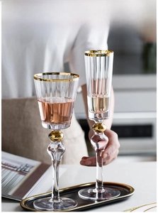 Detail of lead-free crystal glass wine cup with gold rim and vertical ribbed texture
