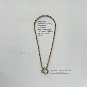 Detail of 4mm stainless steel 18K gold chain with a silver horseshoe clasp mechanism