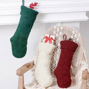 Three-piece cable knit Christmas stockings in dark green, ivory white, and burgundy colors
