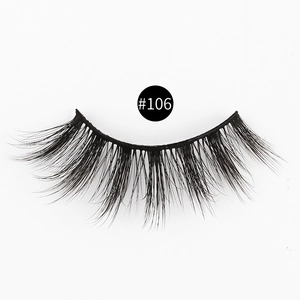 Macro shot of 3D thick false eyelashes style #106 with natural curved fibers on white background