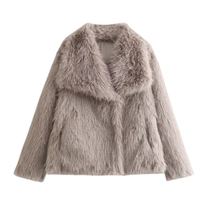 Macro detail of the plush faux fur texture and wide lapel on light gray short jacket