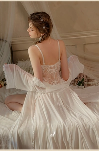 Close-up of elegant white lace lingerie set with sheer mesh robe and floral embroidery