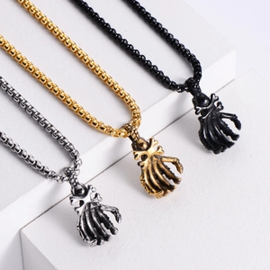 Punk skeleton hand pendants in silver, gold, and black metal on white display stands