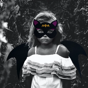 Detail of kids black bat wings and glittery cat ear mask for Halloween cosplay party costumes