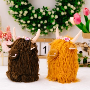 Close-up of brown and ginger Highland Cow plush toys featuring floral headbands and soft fur