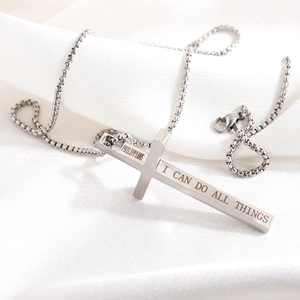 Detail of silver stainless steel cross pendant with Philippians scripture engraving