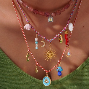 Bohemian multi-layer necklace set with sun, moon and pink crystal pendant detail