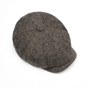 Top view of men's tweed newsboy cap with grey herringbone pattern and wool blend texture