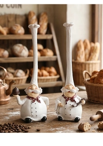 Detail of creative resin chef figurines with elongated hats on a rustic wooden table