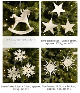Macro detail of white frosted Christmas ornaments including rocking horse and snowflake designs