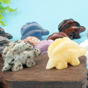 Detailed close-up of hand-carved crystal dinosaur figurines in various gemstones