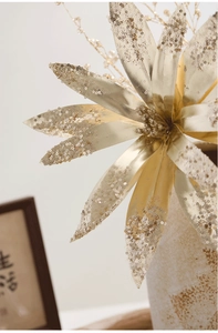 Macro detail of golden artificial Christmas flower with shimmering sequins and petals