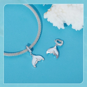 Detail of s925 sterling silver mermaid tail charm with white opal inlay on snake chain
