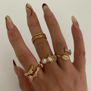 Vintage gold geometry rings set with moonstones and leaf patterns on female hand