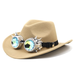 Detail of steampunk goggles with metal spikes and colorful lenses on a khaki felt cowboy hat