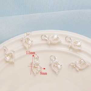 Detailed view of silver dolphin DIY pendant charms with dimensions 15mm by 8mm